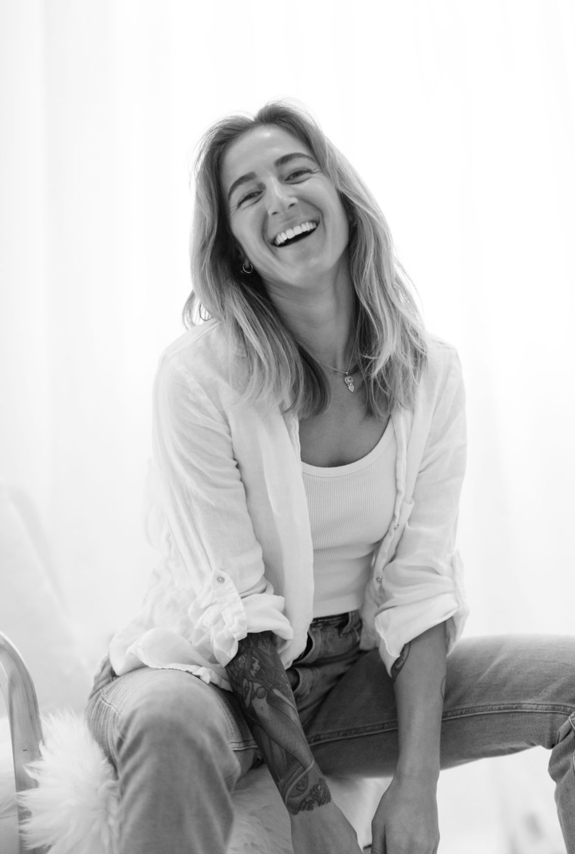 Andrea smiling, seated in her studio